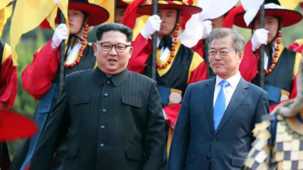 North Korean leader Kim Jong-un, left, and South Korean President Moon Jae-in walk together through a honour guard at the border village of Panmunjom in the Demilitarized Zone. 