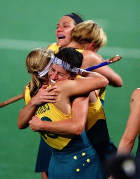 Australian team members embrace after winning the gold medal. 