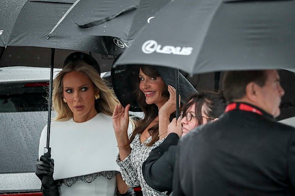 Supermodel Helena Christensen arrives at Derby Day, sheltered from the rain.