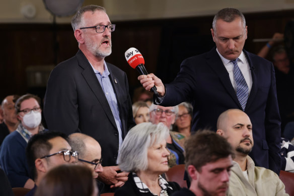 John asks a question at the forum on Tuesday night. 