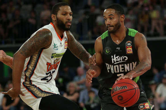 Red-hot import John Roberson, right, came through in the clutch for Phoenix against the Taipans.