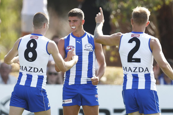 New Roo Harry Sheezel (centre) made an impact for North Melbourne against Richmond.