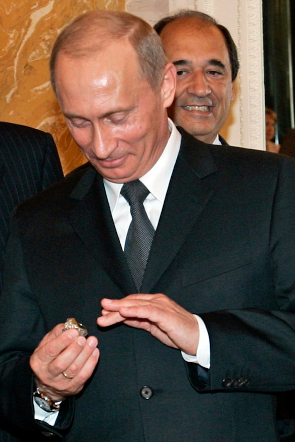 Putin was famously accused of stealing a $25,000 diamond ring after the 2005 Superbowl (pictured in his hands).