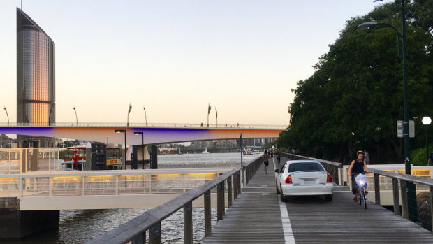 Pedestrians watch on as police stop a car on the South Bank pedestrian boardwalk near the Kurilpa Bridge.