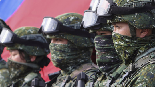 Taiwanese soldiers pose with a Taiwan flag after a preparedness enhancement drill in January simulating the defence against Beijing’s military intrusion.