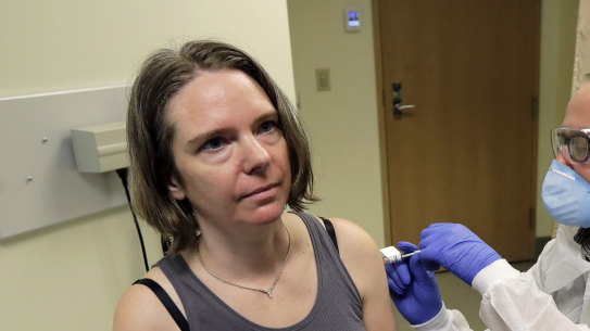 A pharmacist gives Jennifer Haller, left, the first shot in the first-stage safety study clinical trial of a potential vaccine for COVID-19, at the Kaiser Permanente Washington Health Research Institute in Seattle. 