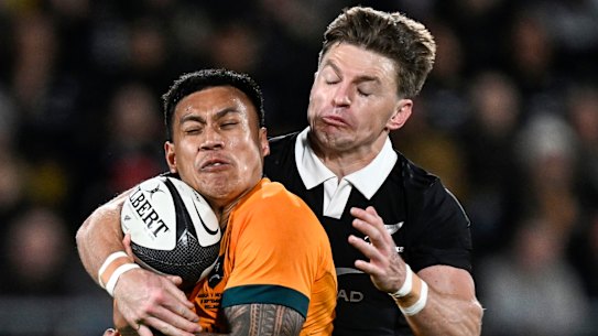 Australia’s Len Ikitau is tackled by New Zealand’s Beauden Barrett, right, during their Rugby Championship match between the All Blacks and the Wallabies in Wellington, New Zealand, Saturday, Sept. 28, 2024.(Andrew Cornaga/Photosport via AP)