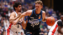Luke Travers of Melbourne United drives at the basket.