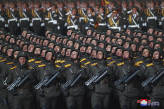 North Korean soldiers march in formation during a military parade.