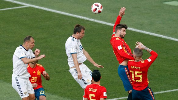 Hands down: Gerard Pique raises his arm to give away the equalising penalty in regular time.