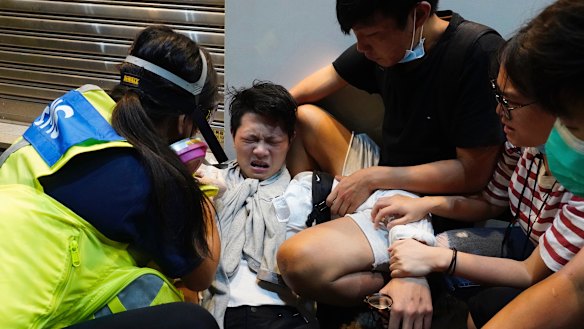 A protester affected by pepper spray is attended to during the rally.