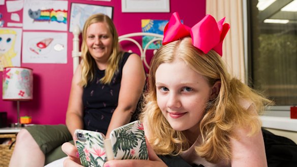 Sharon Kley with her daughter Kristanna Kley 11, who uses her mobile phone to check her insulin levels at school for her type 1 diabetes. 