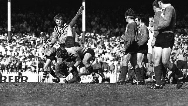 Tiger tough: A Rabbitohs player is taken to ground in a full-blooded tackle during the 1969 grand final.