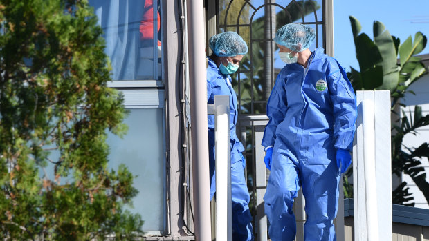 Forensic officers comb the Bent Street house on Monday.