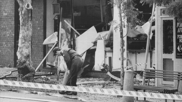 A police officer searches for clues outside the Turkish embassy after the bombing.