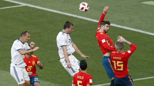 Hands down: Gerard Pique raises his arm to give away the equalising penalty in regular time.
