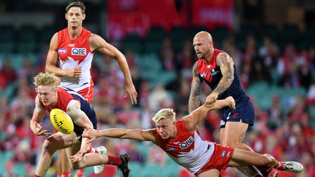 Melbourne's Clayton Oliver contests with Swan Isaac Heeney.