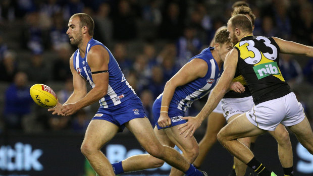 Cool under pressure: Ben Cunnington racks up another possession for North against Richmond.