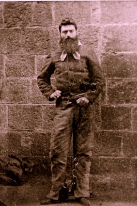Portrait of Ned Kelly taken in Melbourne Gaol by Charles Nettleton, showing him hiding his withered left hand and arm by holding the cord attached to the leg iron.