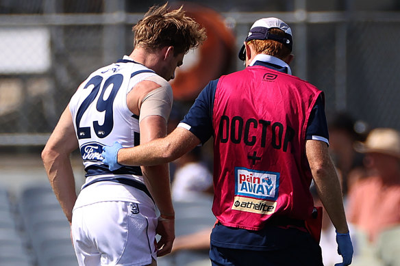 Cam Guthrie limps off the field in the match simulation against Carlton on Thursday.