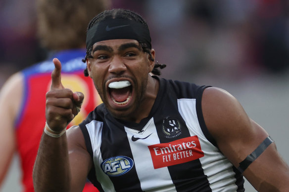 Isaac Quaynor of the Magpies celebrates kicking a goal.