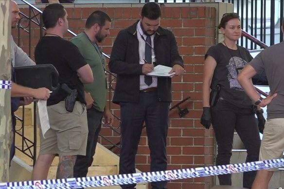 Police at the crime scene outside Blacktown Police Station.