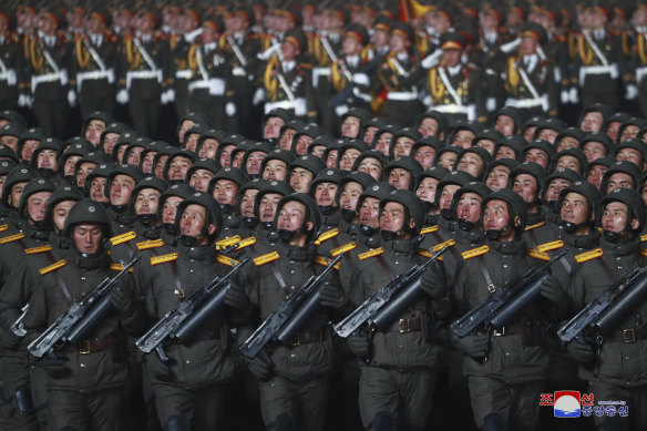 North Korean soldiers march in formation during a military parade.
