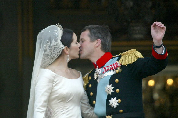 Then-crown prince Frederik kisses his bride, Mary Donaldson, on the balcony of the Amalienborg Palace in Copenhagen, in May 2004.