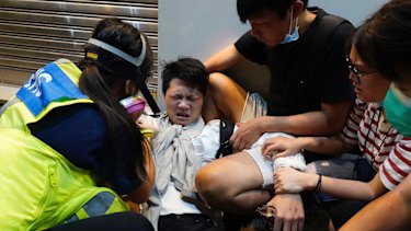 A protester affected by pepper spray is attended to during the rally.