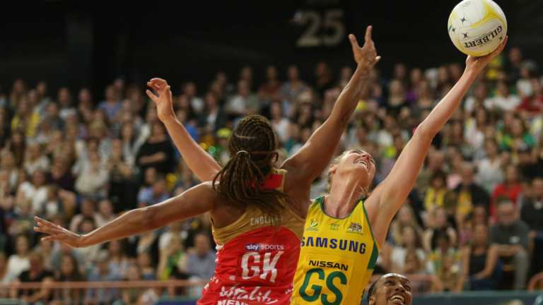 Stretched: Caitlin Bassett reaches for the ball at Newcastle Entertainment Centre. 