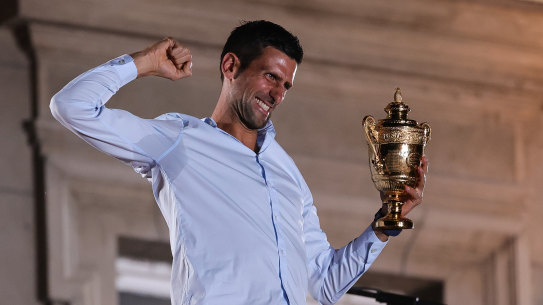 Novak Djokovic celebrates with the Wimbledon trophy in front of Belgrade City Hall.