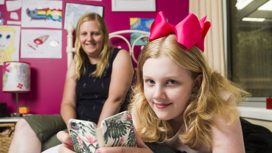 Sharon Kley with her daughter Kristanna Kley 11, who uses her mobile phone to check her insulin levels at school for her type 1 diabetes. 