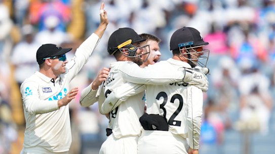 The final wicket: New Zealand players celebrates the dismissal of India’s Washington Sundar.