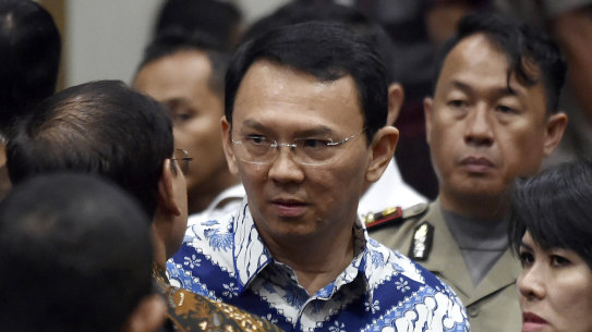 Former Jakarta governor Basuki "Ahok" Tjahaja Purnama,, talks to his lawyers after his sentencing in May last year.