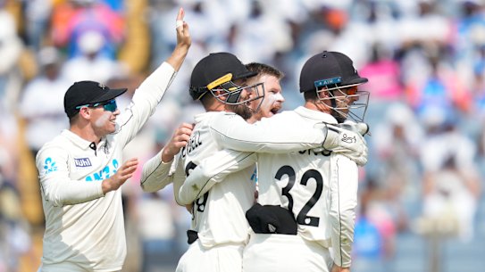 The final wicket: New Zealand players celebrates the dismissal of India’s Washington Sundar.