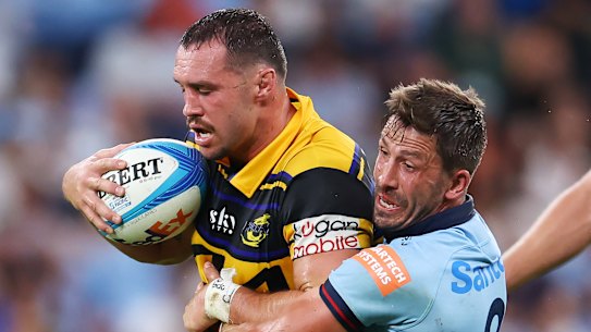 SYDNEY, AUSTRALIA - MARCH 06: Jake Gordon of the Waratahs tackles during the round four Super Rugby match between NSW Waratahs and Hurricanes at Allianz Stadium, on March 06, 2026, in Sydney, Australia. (Photo by Jeremy Ng/Getty Images)