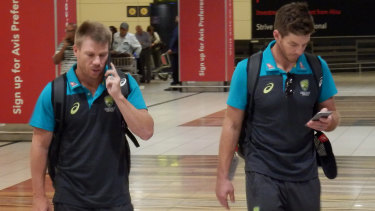 David Warner and stand-in skipper Tim Paine arrive at Johannesburg airport on Tuesday.