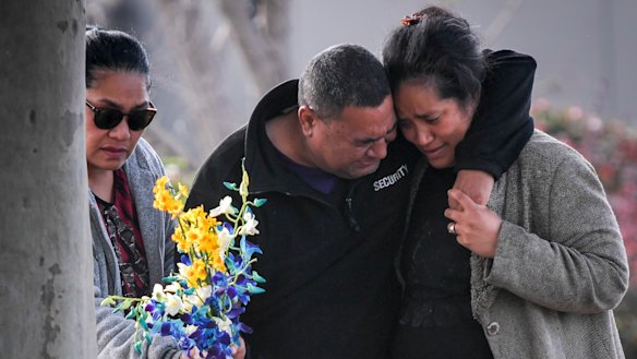 Solomone's parents Salome (right) and 'Atunaisa (centre) visit the scene where their son was killed.