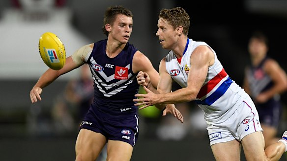 Best in show: Western Bulldogs' Lachie Hunter handballs under pressure on Sunday night.