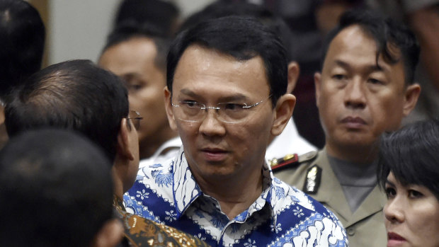 Former Jakarta governor Basuki "Ahok" Tjahaja Purnama talks to his lawyers after his sentencing in May 2017.