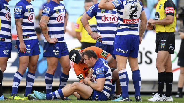 Trouble breathing: Josh Morris stays down after a collision with Sam Burgess. 