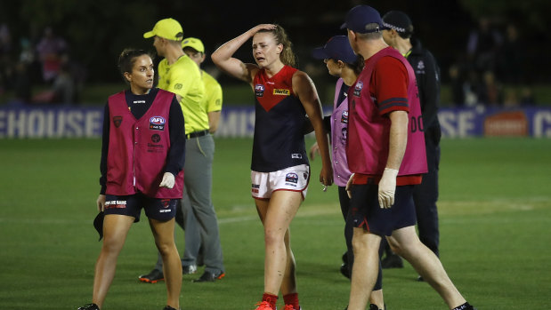 Ainslie Kemp leaves the field injured on Friday. 