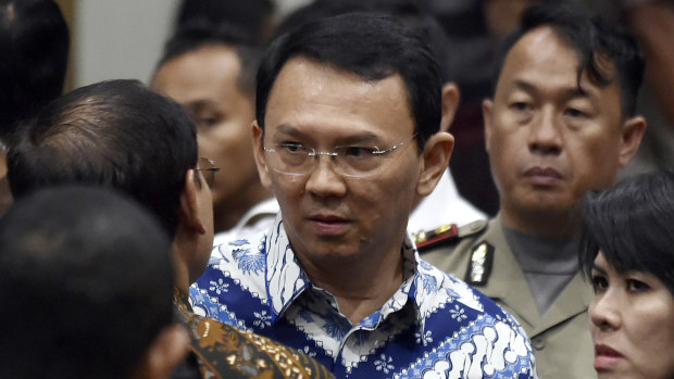 Former Jakarta governor Basuki "Ahok" Tjahaja Purnama,, talks to his lawyers after his sentencing in May last year.