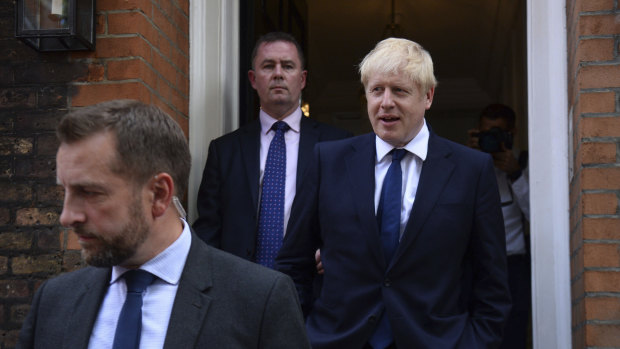 Fit for the job? Boris Johnson, right, leaves his office in London.