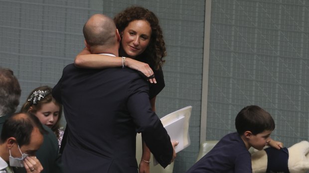Treasurer Josh Frydenberg is embraced by his wife Amie Frydenberg before delivering the budget speech in the House of Representatives on Tuesday.