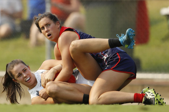 Libby Birch, pictured tackling Magpie Chloe Molloy in round five, is hopeful the MCG will play host to more AFLW games in future. 