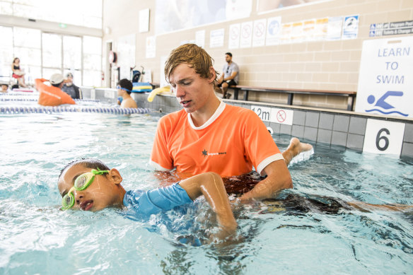 Aaron Wartmann, a swimming instructor at Auburn Ruth Everuss Aquatic Centre, with six year old Jayden Yang.  