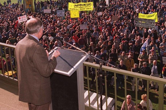 Prime Minister John Howard addresses a gun rally with a protective vest under his jacket.