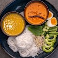 Khanom jeen (rice noodles with curry and condiments).