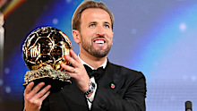 Harry Kane holds aloft the Ballon d’Or trophy.